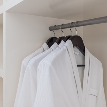 white-bathrobe-with-wooden-hangers-in-wardrobe-psapb58.jpg