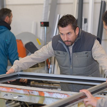 men-working-at-plastic-door-and-window-factory-p7wyt83.jpg